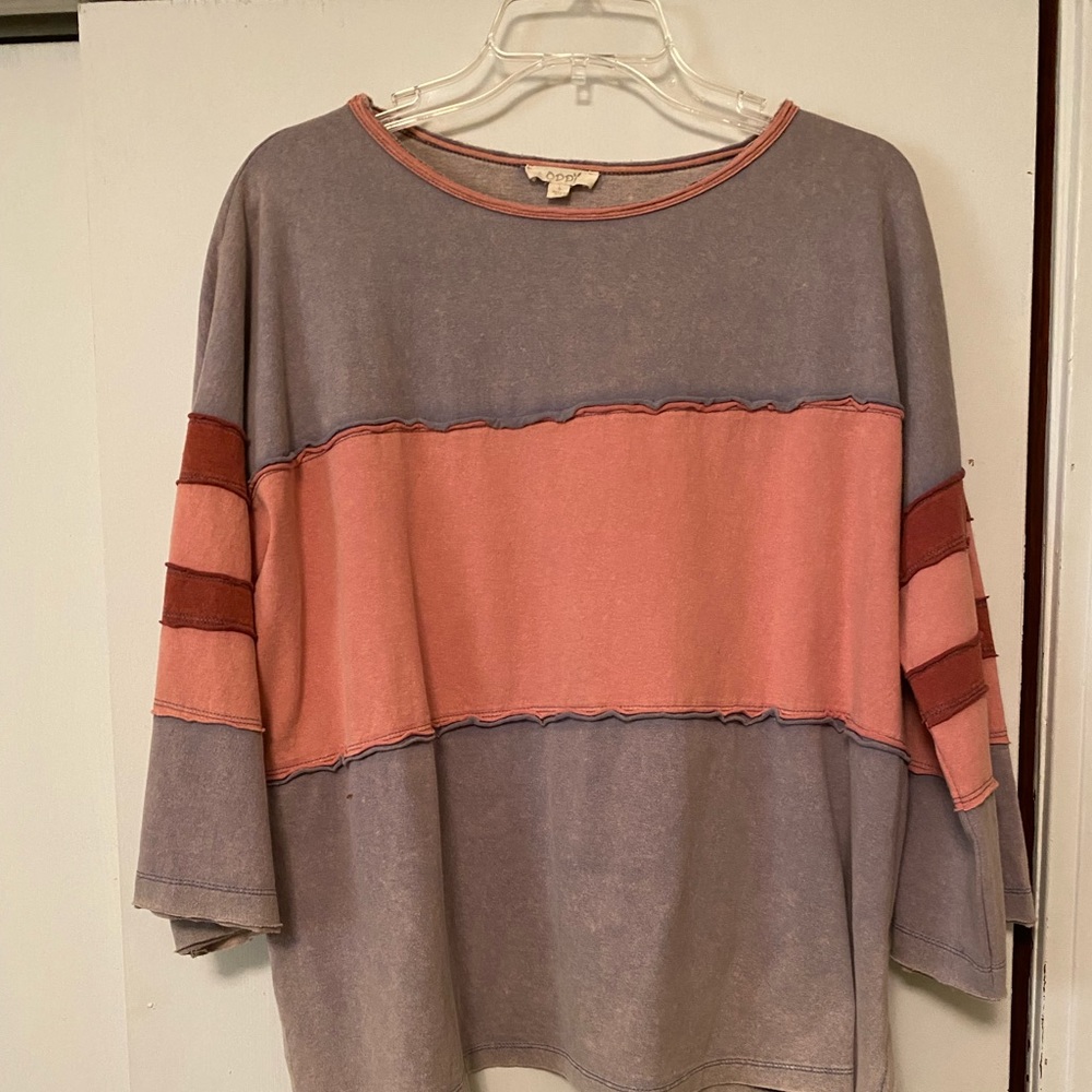 Oddly brand Size L Muted colors and has a bleached color to the top.